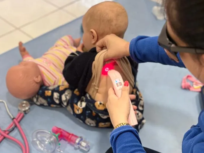 Fisioterapeuta em atendimento de fisioterapia respiratória com bebê